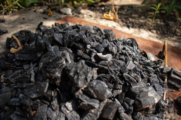 Natural fire ashes. Dark grey, black coals texture. Burnt out bonfire