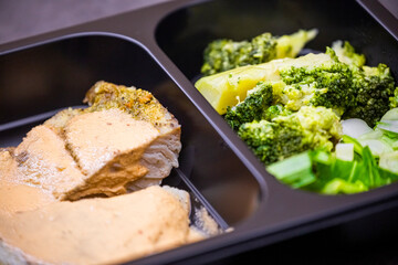 Healthy takeaway food in a box. Steamed fish, then choi, broccoli and chili sauce. Fresh food, light dinner. Healthy eating