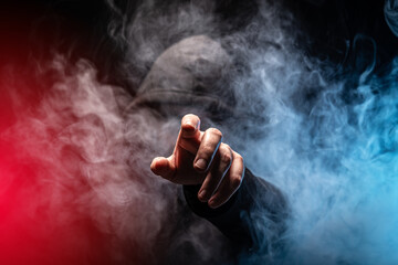 Hacker in a smoke-filled background - obrazy, fototapety, plakaty