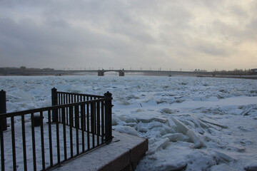 Ice hummocks on the river in the city near the waterfront on a cloudy day at sunset as a natural background or texture © Elena