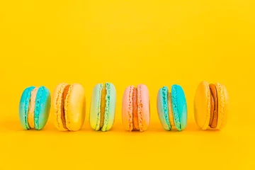 Fototapete Rund Sweet almond colorful unicorn pink blue yellow green macaron or macaroon dessert cake isolated on trendy yellow modern fashion background. French sweet cookie. Minimal food bakery concept Copy space © Юлия Завалишина