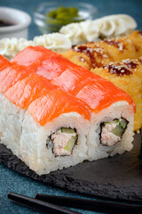 Sushi rolls philadelphia with salmon, cream cheese and cucumber close-up. Sushi menu, japanese kitchen.