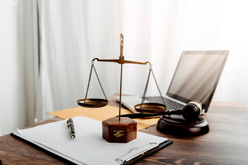 Justice and law concept.Male judge in a courtroom with the gavel, working with, computer and...