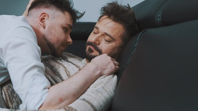 Happy Gay Couple Snuggling On The Couch. Close Up. High Quality 4k Footage