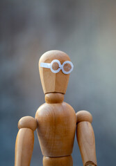 Close up wooden mannequin with glasses