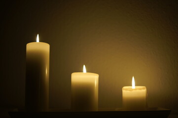 Three candles burning in the dark