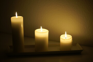 Three candles burning in the dark
