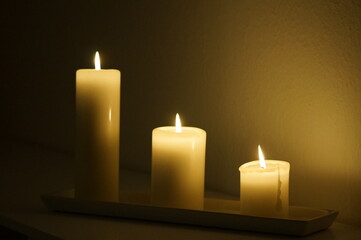 Three candles burning in the dark