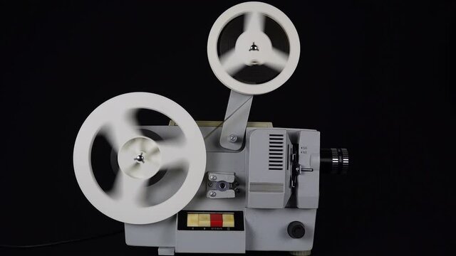 Rewinding Tape In An Old Movie Projector.