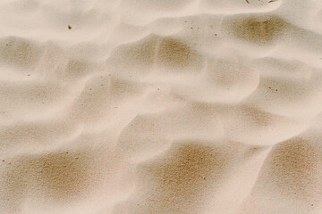 sand dunes close-up view from above. Background beige photo. sand waves. texture of sand on the beach