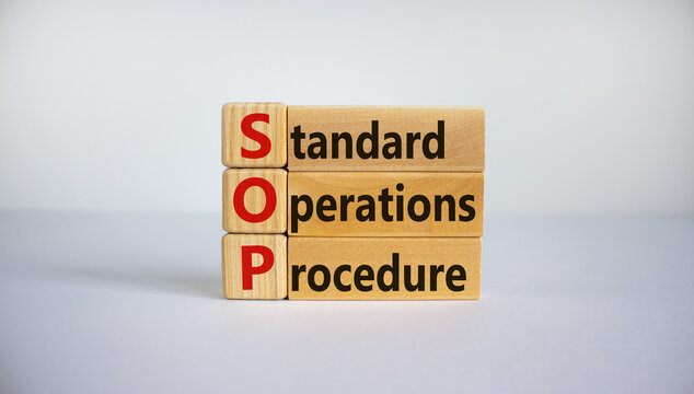 SOP - standard operations procedure symbol. Concept word 'SOP - standard operations procedure' on cubes and blocks on a beautiful white background. Business and SOP concept. Copy space.