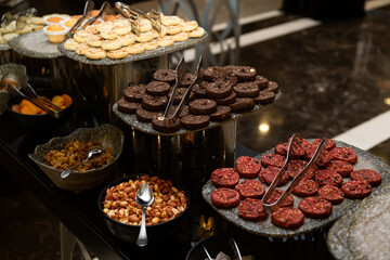 Buffet table with various cookies and biscuits, tarts and cakes