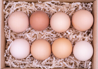 Homemade eggs in a craft box. Top view. Eco-friendly products.