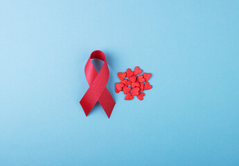 Red ribbon with small red hearts, the day of struggle against AIDS