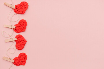 Valentine's day background with hanging red hearts. Flat lay, top view,copy space.