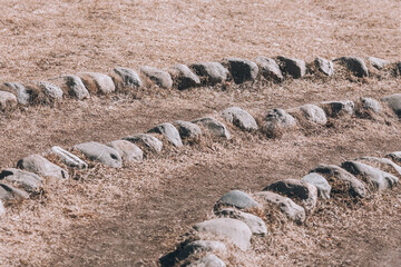 Stone labyrinth. Many small cobblestones lined with a pattern
