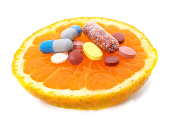 Sliced orange with pills.