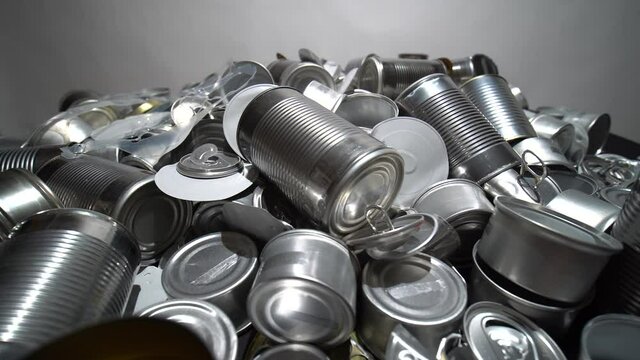 Metal tins, cans and jar garbage from household on the table. City home trash made of aluminum. Empty used, food and drink steel packaging waste and scrap discarded sorted and ready to recycle.