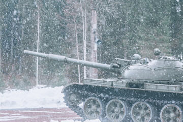 Tank during a snowfall. Army tank, side view