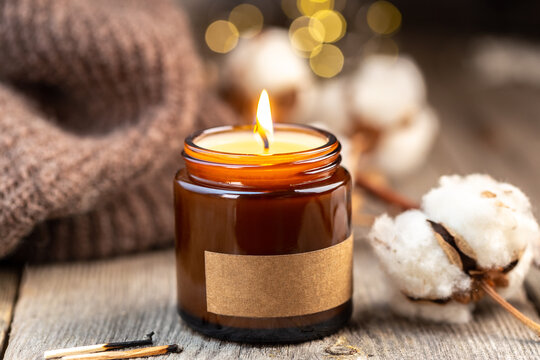 Burning candle in a glass jar with label mock up