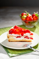 piece of cake on white plate with strawberries