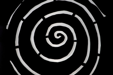 White spiral on black background. Intermittent lines. Paper cut.