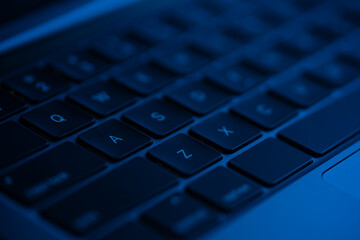 Macro shot view of laptop keyboard . Concept of working, writing e-mails, using Internet.