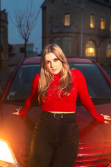 Young woman recording herself with a cell phone at the street.