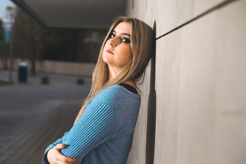 Young blonde woman outside on the street