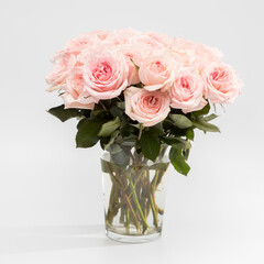 Rose White Pink O'hara. Bouquet of pink roses are in a glass vase.