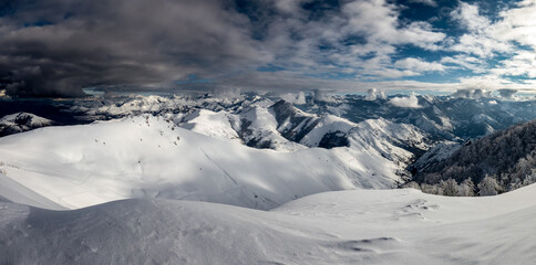 Fototapeta premium Black clouds are approaching the snowy mountains.