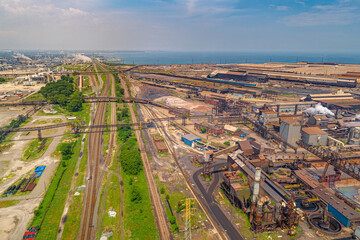 Aerial View of Vast Industrial Landscape. Steel Mills and Heavy Industry, Rail Lines, Bridges, Shipping Canal, Harbor, etc.