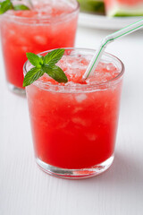 Summer cold drink with watermelon and mint on a white wooden background