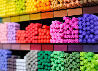 Background of different colors pens on store shelves. Art store, workshop, stationery.