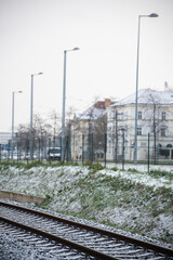 Snowing day on Prague. People walk on Park Letna while tram travel through the city, close to Hradcanska in Prague 6