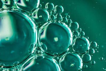oil drops on water on blue background
