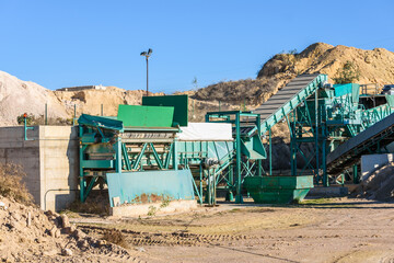 Machinery in a rock quarry to crush and sand the stone.