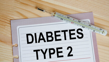 On a sheet from the daily text DIABETES TYPE 2, next to the thermometer.