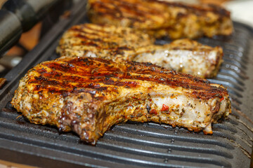 grilling steaks on a flaming grill