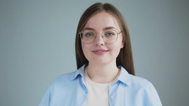 Attractive happy chubby girl in eyeglasses looking at camera and smiling success