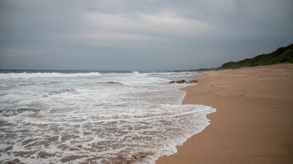 Beautiful coast of the Indian Ocean in cloudy weather.