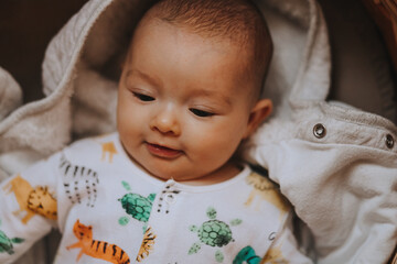 Candid shot of three month old infant baby  during day nap time. Dry and healthy body and skin for children concept. Baby nursery