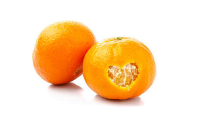 Tangerines on a white background with carved hearts in a peel