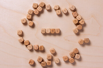 Word denoting next consists of wooden cubes with letters. Wooden cubes with letters images. Word denoting next word concept