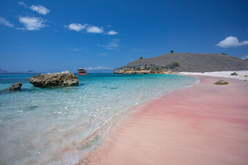 soft waves crashing on the remote pink beach in Komodo National Park in Indonesia