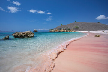 soft waves crashing on the remote pink beach in Komodo National Park in Indonesia