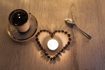 Obraz na płótnie Canvas love of coffee, symbol of love, shape of heart from coffee beans