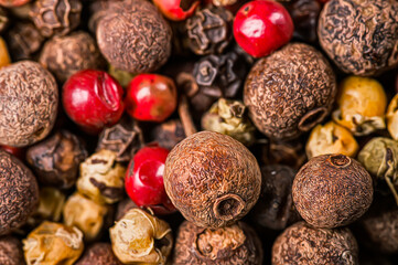 Background of a mixture of allspice for cooking different dishes, a very close-up view from above, photo stylized as an oil painting.