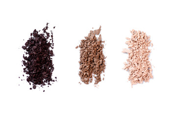cosmetic shadows of three different colors on a white isolated background