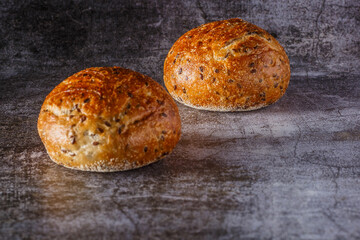 Assortment of baked bread on wooden table background Fresh fragrant bread on the table. Food concept.